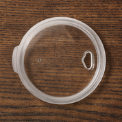 Clear plastic lid for 3ooz and 32oz tumblers on wood surface