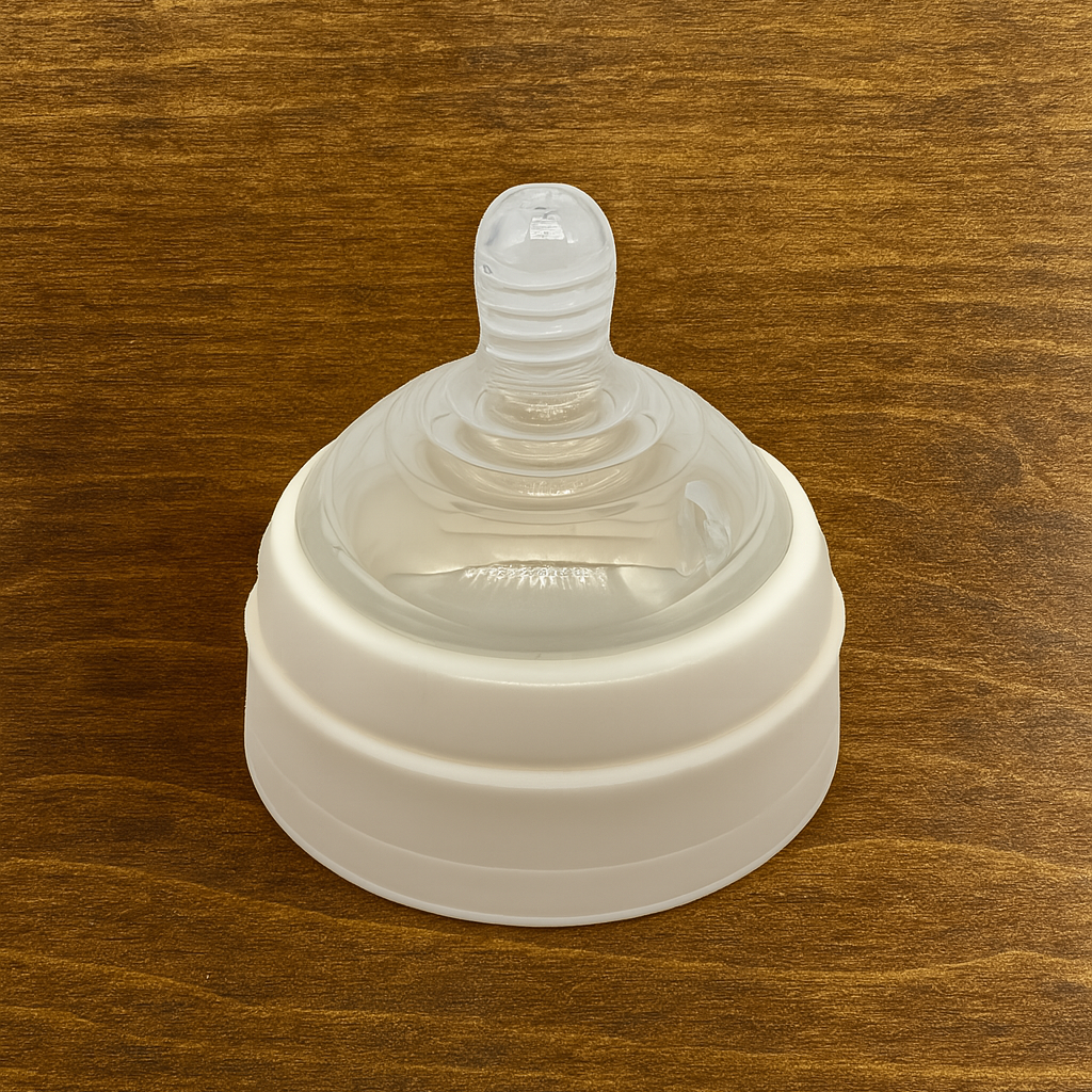 White 9oz baby bottle lid with nipple on wood-surface