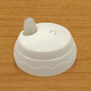 White plastic 9oz Sippy Cup lid on wood surface