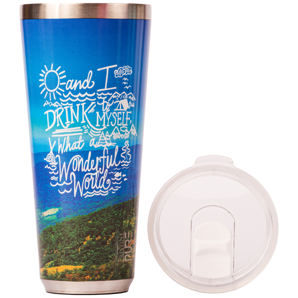 Blue insulated tumbler with scenic design and white lid with text saying "And I drink to myself, what a wonderful world" on a white background
